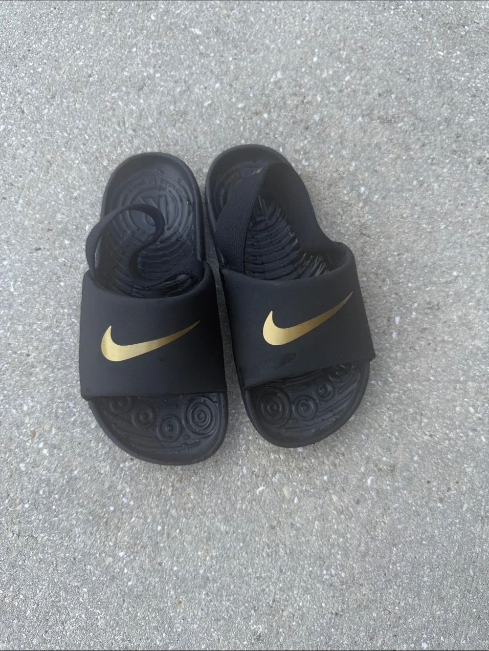 Nike Black Slides with Gold Swoosh